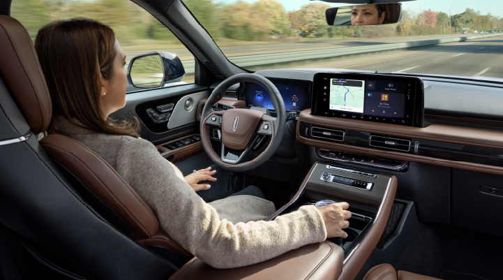 A woman is seen sitting in the driver’s seat of her 2025 Lincoln Aviator® SUV with her hands off the steering wheel. | Don Franklin Lincoln in London KY