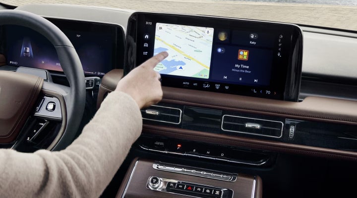 A person is tapping the center display touchscreen of a 2026 Lincoln Aviator® SUV. | Don Franklin Lincoln in London KY