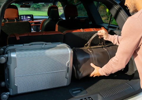 A man loads luggage into the rear of a 2026 Lincoln Aviator® SUV through the opened rear liftgate. | Don Franklin Lincoln in London KY