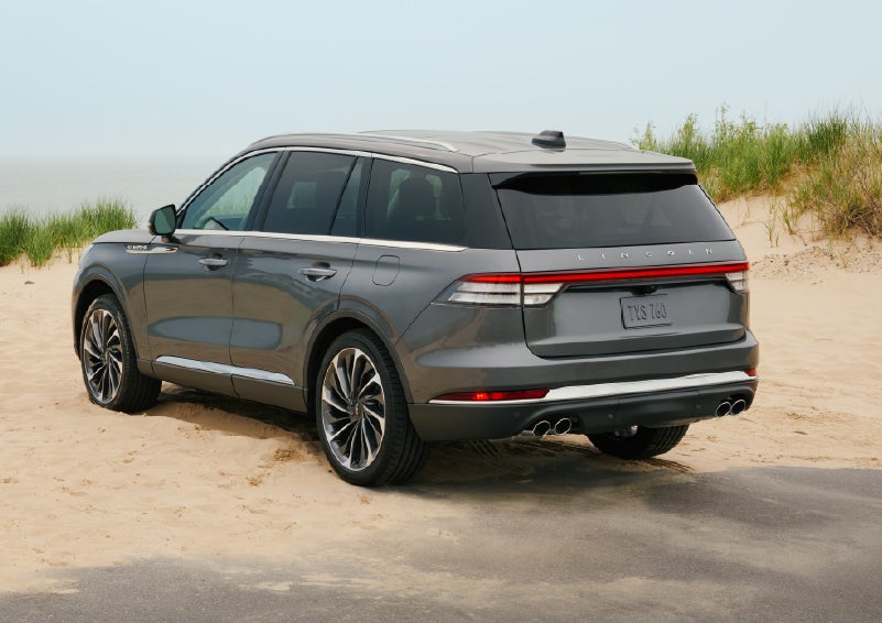 A 2027 Lincoln Aviator® SUV is parked next to sand dunes. | Don Franklin Lincoln in London KY