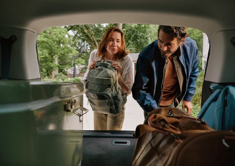 A couple loads luggage into the rear of a 2027 Lincoln Aviator® Black Label™ SUV..e 202 | Don Franklin Lincoln in London KY