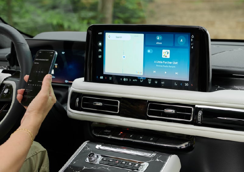 A person pairs thier phone with the center touchscreen of a 2027 Lincoln Aviator® Black Label™ SUV | Don Franklin Lincoln in London KY